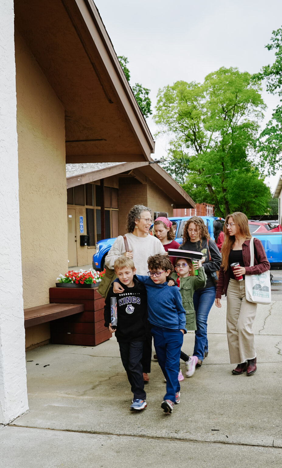 Children and adults arriving together at New Hope Christian Fellowship